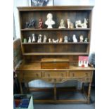 A Reproduction oak dresser and rackback having five drawers, 157 cms