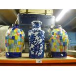 A pair of pottery lamps with a blue and white vase