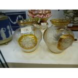 A pair of Bohemian amber and clear glass vases, decorated flowers