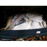 A suitcase full of vintage black and white plates