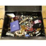 A black metal box containing a small quantity of costume jewellery