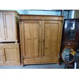 Large continental pine 2 door wardrobe on raised base and bun feet