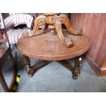 Peruvian leather topped circular coffee table on mahogany frame