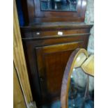 An oak hanging corner cupboard