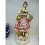 Large Capodimonte figure of a lady collecting flowers