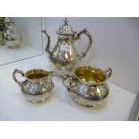 A silver coffee pot, sugar bowl and milk jug combined weight approx 57.24 oz, with an ornate surface