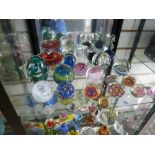 A quantity of glass paperweights to include examples by Midina, Caithness etc.