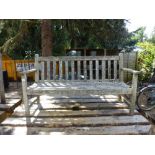 A weathered teak outdoor bench