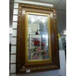 Two oak framed and glazed decorative bevelled mirrors