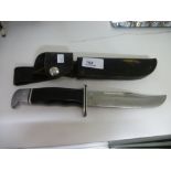 A genuine hunting knife sheathed