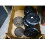 A box of black weights in cast iron