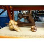 Three teak figures of human forms in a crouched sitting position