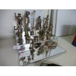 A collection of silver plate figures depicting various Victorian folk