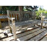 A weathered teak outdoor bench