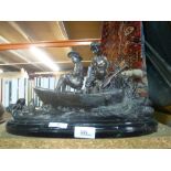 A bronze sculpture of a boy and girl in a fishing boat, of recent manufacture