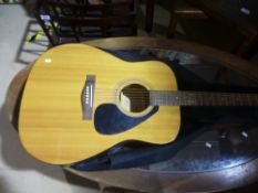 A Yamaha F-310 acoustic guitar and case