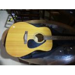 A Yamaha F-310 acoustic guitar and case