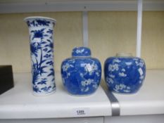 A pair of Chinese blue and white ginger jars - one lid - and a cylindrical vase