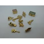 Eleven 9ct yellow gold charms including kettle, boot, key, clog, etc, all marked 375, total weight