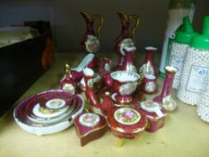 A quantity of red and gold Limoges porcelain