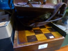 A wooden draughts board that doubles up as a backgammon board, also a small vintage case with a
