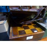 A wooden draughts board that doubles up as a backgammon board, also a small vintage case with a