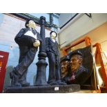 A large resin figure of Laurel & Hardy leaning agaist a lamp post along with an oval plaque also