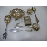 A silver lot containing spoons, tongs, napkin ring, dish, knife and matchbox cover, some marked