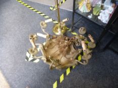A gilt metal chandelier having alabaster bowl decorated ram's heads and a modern adjustable standard