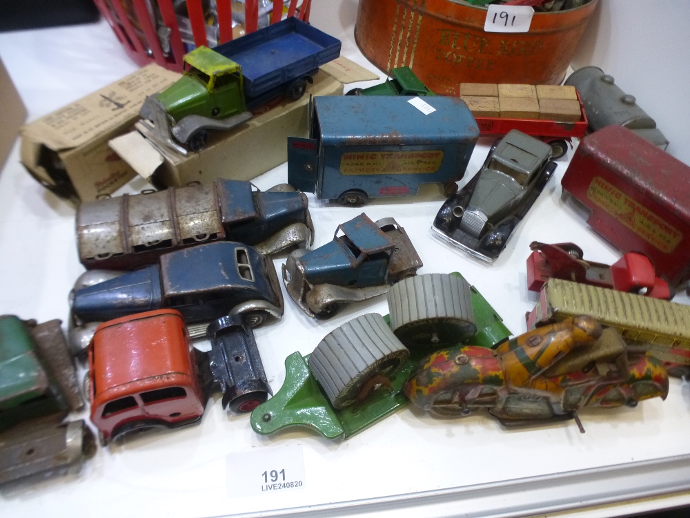 A quantity of vintage tin toy vehicles