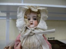 A German bisque head doll numbered 390