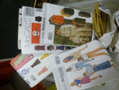 A box of mixed sewing patterns of mostly 1980s and 90s styles