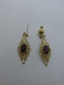 Pair of pretty 9ct yellow gold drop earrings, each set with a purple stone, one back missing, marked