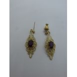 Pair of pretty 9ct yellow gold drop earrings, each set with a purple stone, one back missing, marked