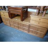 A large Nathan teak sideboard, a nest of coffee tables having tiled tops and sundry