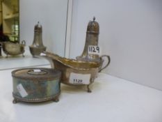 A silver lot comprising of a large sugar shaker, worn, a music box marked London and a dish marked