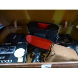 A vintage case of cameras, binoculars, etc