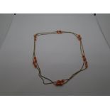 9 carat gold necklace stamped 375, with what appear to be coral beads, gross weight approx 5.6g