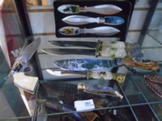 A selection of decorated knives to include boxed set of 3 throwing knives