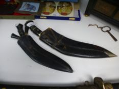 Two Kukri daggers, having black leather sheaths