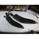 Two Kukri daggers, having black leather sheaths