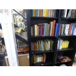 Four shelves of assorted books