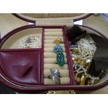 A quantity of costume jewellery contained within a burgundy Leather case