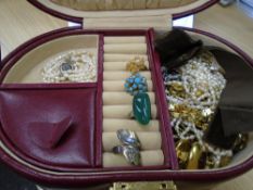 A quantity of costume jewellery contained within a burgundy Leather case