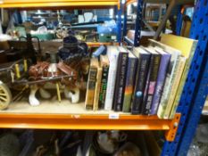 A small selection of books including Agatha Christie, Ian Flemming, and a horse and cart