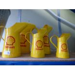 Five Shell oil cans