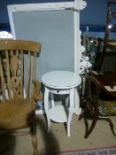 Contemporary circular white bedside table with a drawer and cream painted upholstered head board