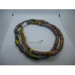 Large string of African hand painted glass beads,