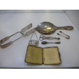 A silver lot comprising of a Martini decanter label, spoon, tongs, mirror and cigarette case gilt