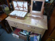 A pine side table having three drawers and a pine dressing mirror